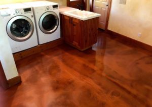Basement laundry room featuring a copper metallic floor coating