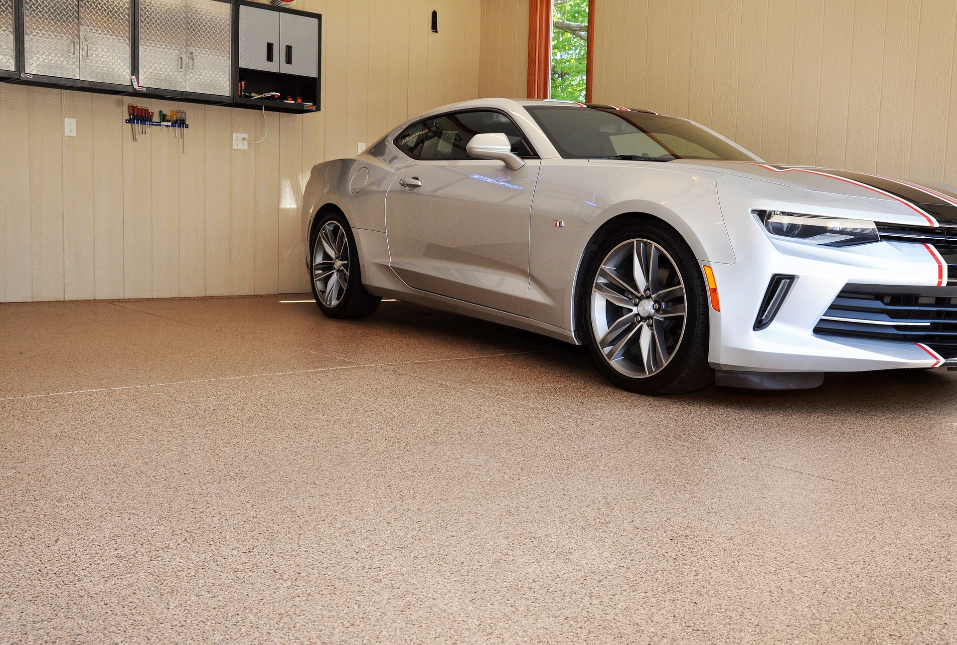Silver sports car parked on a full flake epoxy garage floor