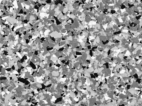 Close-up of a full flake epoxy floor in black, gray, and white chips